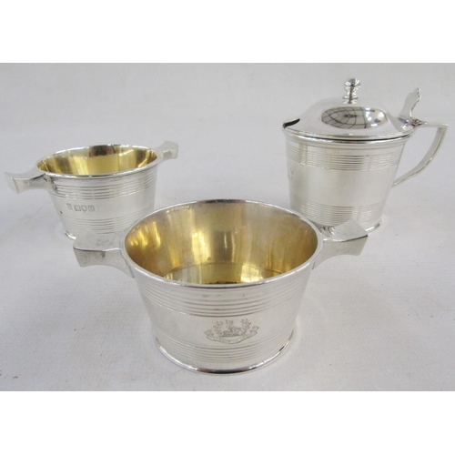 122 - George V Silver engraved armorial mustard pot and two salt cellars, each of cylindrical form with re... 