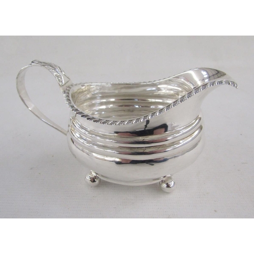 125 - George IV silver milk-jug, of oval form with gadrooned rim and leaf terminal, raised on ball feet, h... 