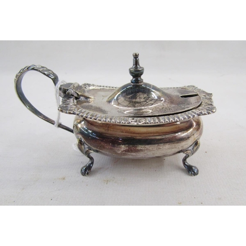 20 - Silver salt, rectangular with gadrooned and foliate everted rim, on scroll supports, the matching mu... 