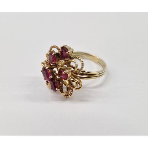 233 - Gold coloured metal ruby and diamond ring, stylised flowerhead set with rubies and small diamonds