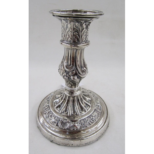 28 - White metal single candlestick, with embossed acanthus leaf and scallop shell decoration, measuring ... 