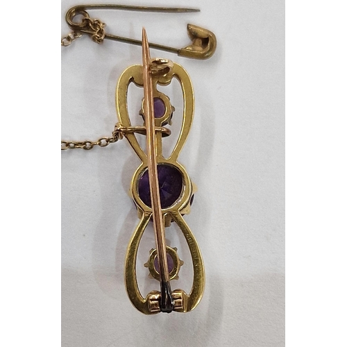 301 - Gold, amethyst and white enamel bar brooch set one large and two smaller amethysts, in case