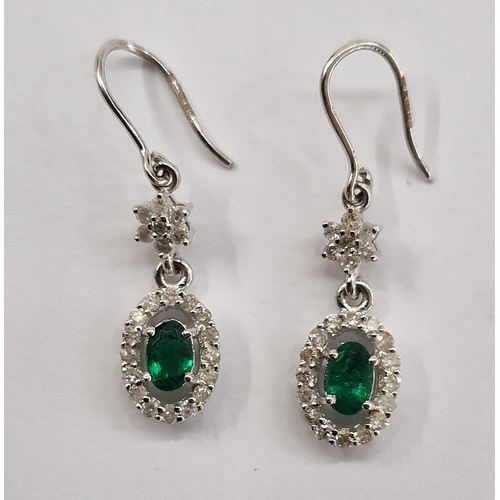 309 - Pair 18ct white gold, diamond and green stone pendant drop earrings with flowerhead above the oval p... 