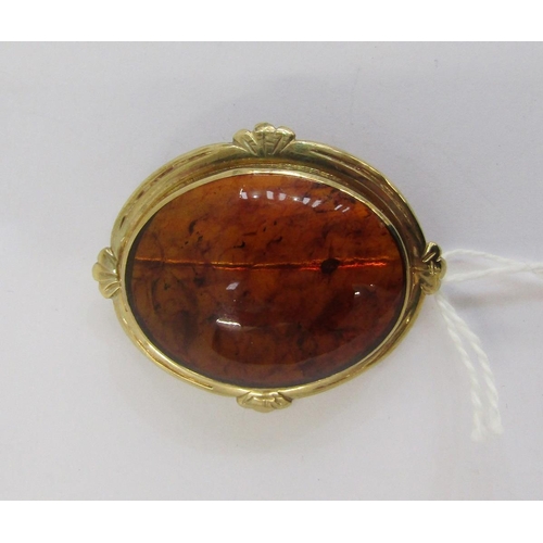 335 - Amber brooch, oval and having 9ct gold hallmarked surround and a white metal and white stone bar bro... 