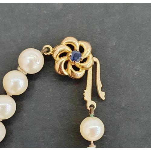 369 - Cultured pearl necklace, graduated and the sapphire set flowerhead clasp, and a cultured pearl neckl... 