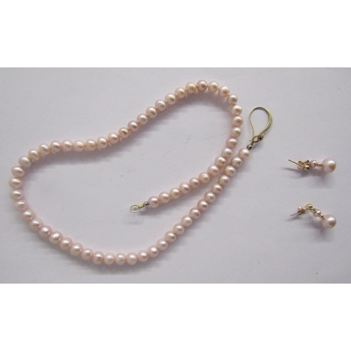 379 - Long string of pink cultured pearls, a shorter string of pink grained cream pearls, two strings of g... 