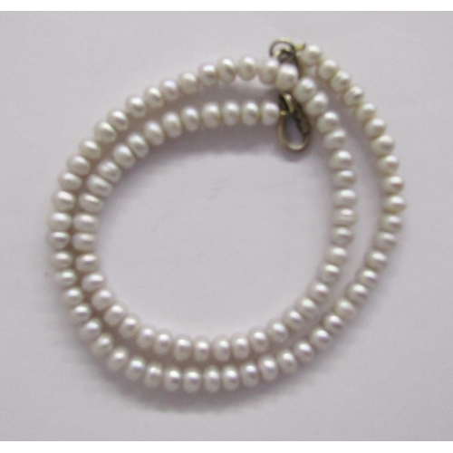 379 - Long string of pink cultured pearls, a shorter string of pink grained cream pearls, two strings of g... 