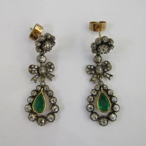 420B - Pair emerald and diamond drop earrings, each in the form of flowerhead diamond cluster above ribband... 