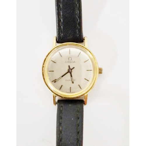 448 - Lady’s Omega rolled gold wristwatch with baton numerals and leather strap