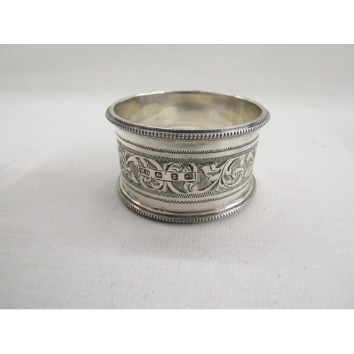 51 - Collection of eight silver napkin rings, of varying designs including pierced and engine turned, gro... 