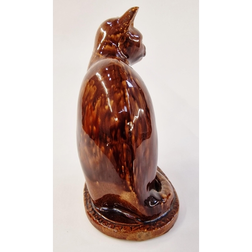 513 - 20th century stoneware Whieldon glazed model of a cat, modelled seated on oval base, enriched in mot... 