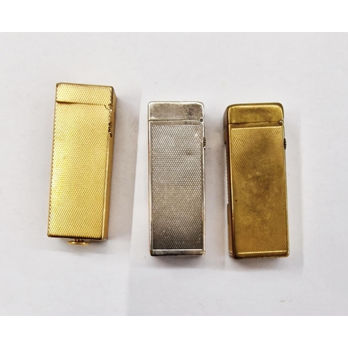 546 - Three mid-century Dunhill lighters, comprising a silver-plated engine turned example and two gold-pl... 