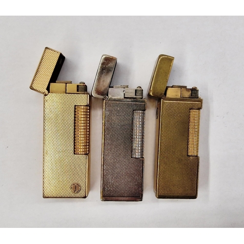 546 - Three mid-century Dunhill lighters, comprising a silver-plated engine turned example and two gold-pl... 