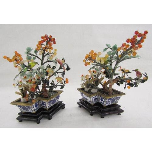 581 - Pair of Chinese enamel hardstone mounted trees, each mounted with a painted tall bird set with berri... 