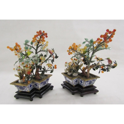 581 - Pair of Chinese enamel hardstone mounted trees, each mounted with a painted tall bird set with berri... 