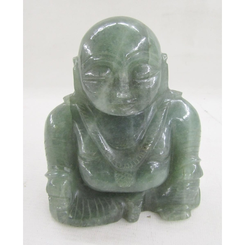 588 - 20th century carved green hardstone figure of a Buddha, modelled seated wearing a long necklace with... 