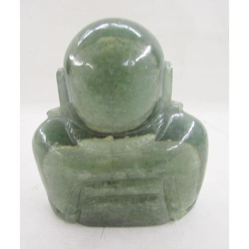 588 - 20th century carved green hardstone figure of a Buddha, modelled seated wearing a long necklace with... 