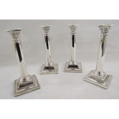 61 - Set of four early 20th century Georgian style silver candlesticks, of Corinthian column form, raised... 