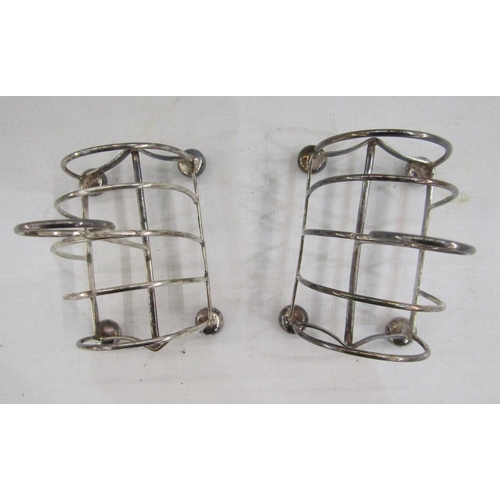 63 - Pair of Edwardian silver four slice toast racks, raised on bun feet, hallmarked Chester 1907, by Geo... 