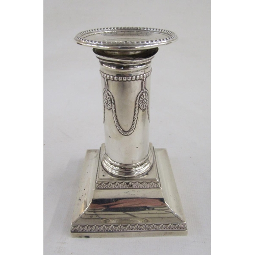 81 - Late Victorian silver pair of squat candlesticks, with wreath and beaded decoration, square bases, h... 