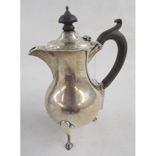 88 - George V bachelor's silver teapot and matching hot water jug, having serpentine everted rim, ebonise... 