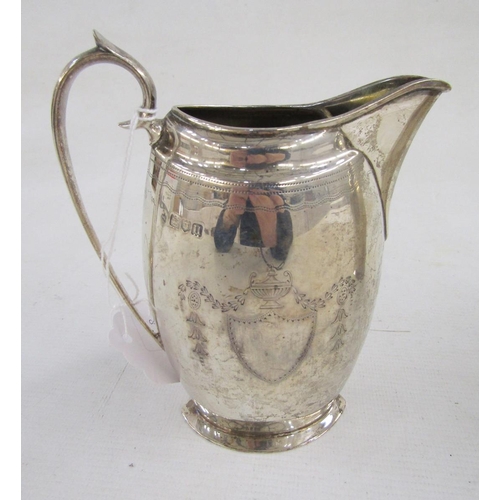 95 - George V silver sugar caster and matching cream jug, each flattened oval, engraved with shield, husk... 