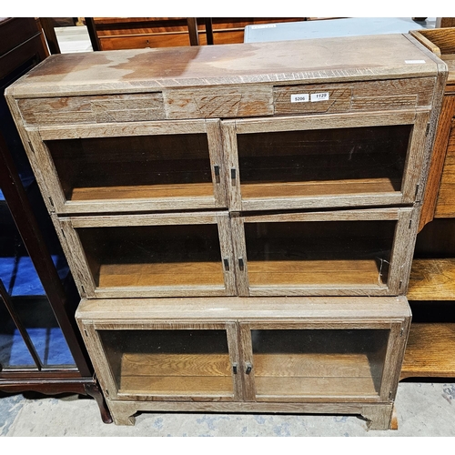 1129 - Limed oak stacking bookcase, three-section, each with two glazed doors, on bracket feet, 120cm high ... 