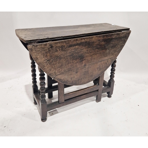 1156 - Antique oak gateleg table raised on turned and square legs, bun feet, 69cm high x 92cm wide x 37cm d... 