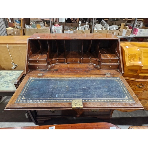 1162 - Georgian mahogany bureau, the fall front opening to reveal a blue gilt leather inset top and an asso... 