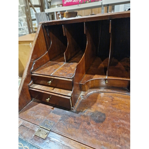 1162 - Georgian mahogany bureau, the fall front opening to reveal a blue gilt leather inset top and an asso... 