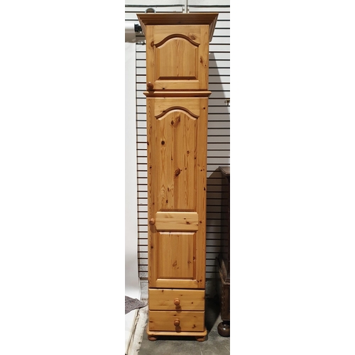 1215 - Modern tall pine narrow wardrobe, surmounted with a panelled cupboard and above two short drawers wi... 