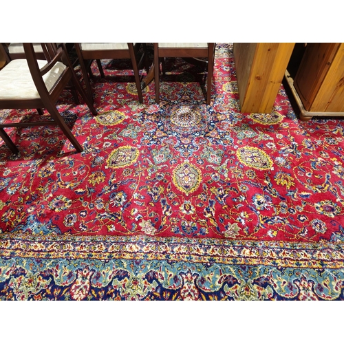 1271 - Large carpet of Persian design, having central floral arabesque and surround of scrolling foliage an... 