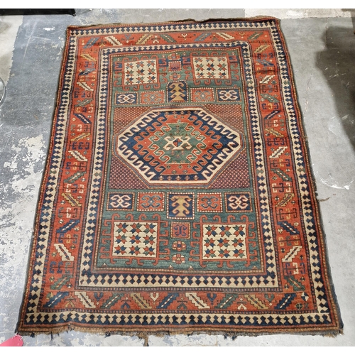 1283 - Caucasian rug with central hooked lozenge on green ground flanked by hooked squares with floral moti... 