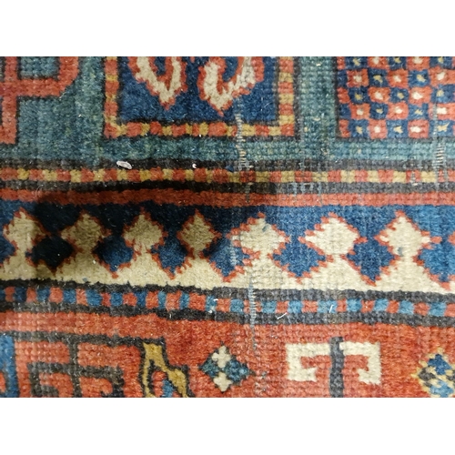 1283 - Caucasian rug with central hooked lozenge on green ground flanked by hooked squares with floral moti... 