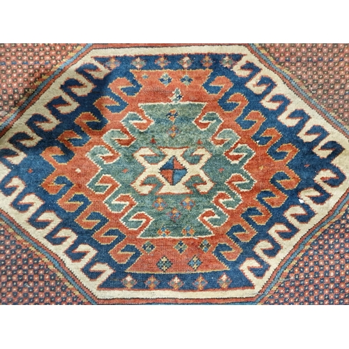 1283 - Caucasian rug with central hooked lozenge on green ground flanked by hooked squares with floral moti... 