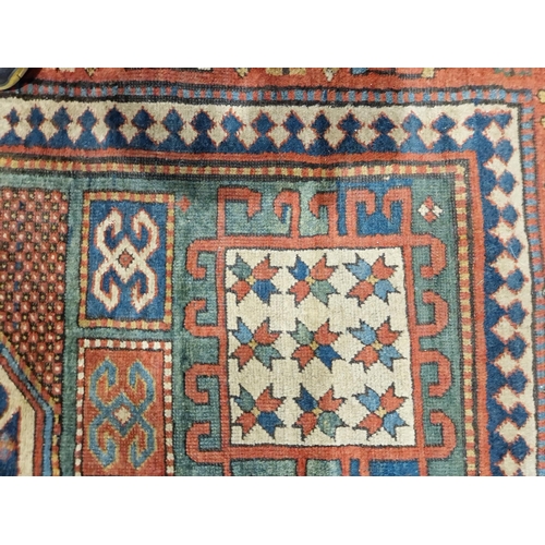 1283 - Caucasian rug with central hooked lozenge on green ground flanked by hooked squares with floral moti... 