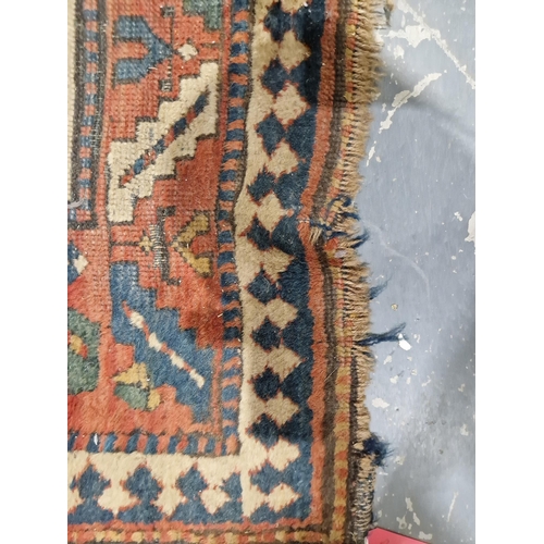 1283 - Caucasian rug with central hooked lozenge on green ground flanked by hooked squares with floral moti... 