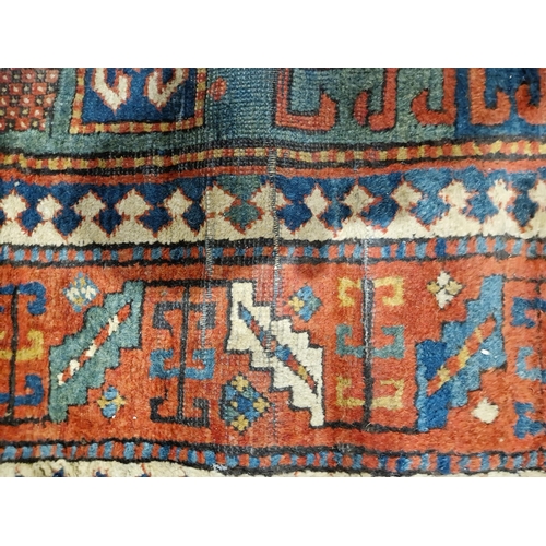 1283 - Caucasian rug with central hooked lozenge on green ground flanked by hooked squares with floral moti... 