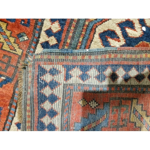 1283 - Caucasian rug with central hooked lozenge on green ground flanked by hooked squares with floral moti... 