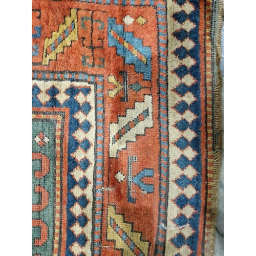 1283 - Caucasian rug with central hooked lozenge on green ground flanked by hooked squares with floral moti... 