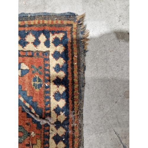 1283 - Caucasian rug with central hooked lozenge on green ground flanked by hooked squares with floral moti... 