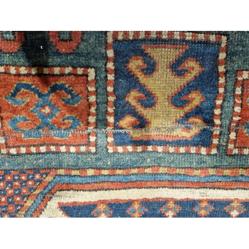 1283 - Caucasian rug with central hooked lozenge on green ground flanked by hooked squares with floral moti... 