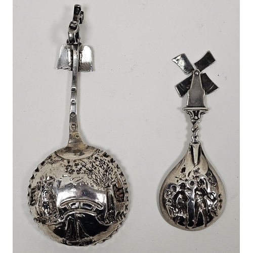 282 - Dutch silver embossed spoon with deep bowl and a similar white metal caddy spoon with moving windmil... 