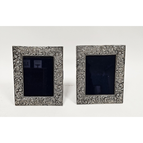 301 - Two 20th century silver-plated photograph frames of rectangular form, embossed in repousse decoratio... 