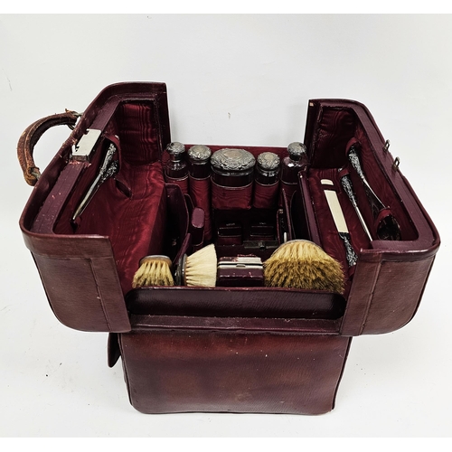 309 - Edwardian red leather travelling gladstone style silver mounted vanity set, containing silver mounte... 