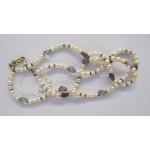 339 - Double-string cultured pearls with heart-shaped amethyst-coloured stones and a Women's Voluntary Ser... 