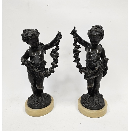 114 - After Moreau, pair of bronze figures of cherubs, the standing boy and girl each holding a garland of... 