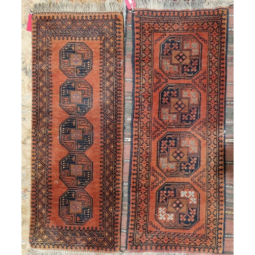 1192 - Two Afghani red ground runners, one with four central quartered elephant foot guls to multiple geome... 