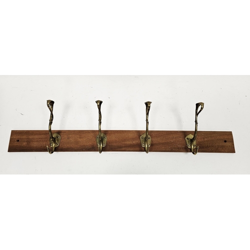 127 - Set of four Art Nouveau brass coat hooks of entwined tendril form, later mounted on a teak plank, 91... 