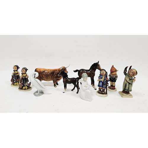 26 - Five Goebel figures of children, a Lladro figure of a swan, a Nao figure of an angel, a Beswick pott... 